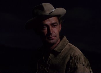Movie still from “Shane” (1953), directed by George Stevens – A man wearing a cowboy hat in the dark; Close Up shot, Low angle