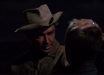 Movie still from “Shane” (1953), directed by George Stevens – A man wearing a cowboy hat is talking to another man; Close Up shot, Over the shoulder angle