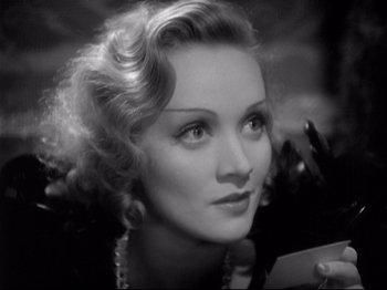 Movie still from “Shanghai Express” (1932), directed by Josef von Sternberg – An old photo of a woman in a black dress; Close Up shot, High angle