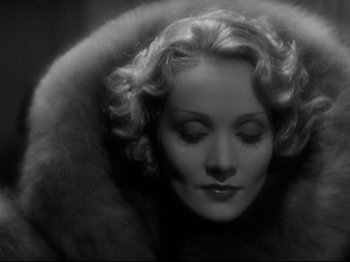 Movie still from “Shanghai Express” (1932), directed by Josef von Sternberg – A black - and - white photo of a woman in a fur coat; Close Up shot, Low angle