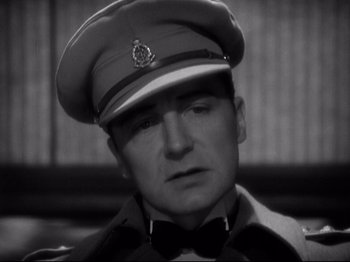 Movie still from “Shanghai Express” (1932), directed by Josef von Sternberg – A black and white photo of a man in a uniform; Close Up shot, Low angle