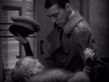 Movie still from “Shanghai Express” (1932), directed by Josef von Sternberg – An old photo of a man and a little girl; Medium shot, Over the shoulder angle