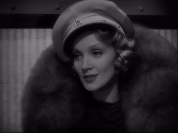 Movie still from “Shanghai Express” (1932), directed by Josef von Sternberg – A black and white photo of a woman wearing a hat; Close Up shot, Low angle
