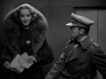 Movie still from “Shanghai Express” (1932), directed by Josef von Sternberg – A man and a woman in military uniforms; Medium shot, Over the shoulder angle