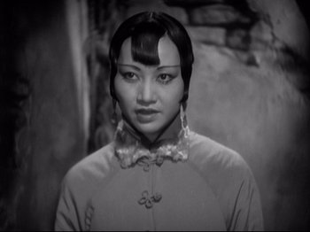 Movie still from “Shanghai Express” (1932), directed by Josef von Sternberg – An asian woman in a black and white photo; Close Up shot, Over the shoulder angle
