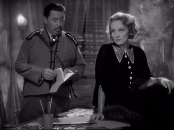 Movie still from “Shanghai Express” (1932), directed by Josef von Sternberg – A man and a woman sitting at a table in a room; Medium shot, Over the shoulder angle