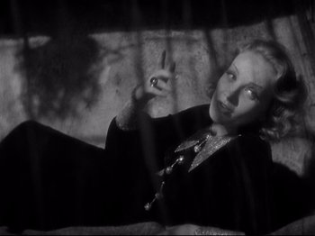 Movie still from “Shanghai Express” (1932), directed by Josef von Sternberg – A black - and - white photo of a woman pointing to the sky; Medium shot, High angle