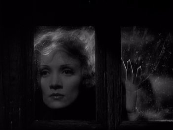 Movie still from “Shanghai Express” (1932), directed by Josef von Sternberg – A black and white photo of a woman looking out of a window; Close Up shot, Low angle