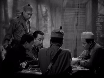 Movie still from “Shanghai Express” (1932), directed by Josef von Sternberg – A group of men sitting around a table; Medium shot, High angle
