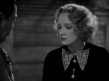 Movie still from “Shanghai Express” (1932), directed by Josef von Sternberg – An old photo of a woman in a black dress; Close Up shot, High angle