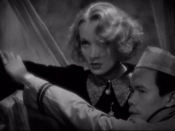 Movie still from “Shanghai Express” (1932), directed by Josef von Sternberg – An old black and white photo of a man and a woman; Close Up shot, High angle