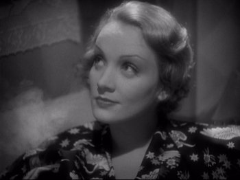 Movie still from “Shanghai Express” (1932), directed by Josef von Sternberg – An old photo of a woman looking at the camera; Close Up shot, High angle