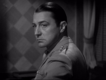 Movie still from “Shanghai Express” (1932), directed by Josef von Sternberg – A black and white photo of a man in a military uniform; Close Up shot, Low angle