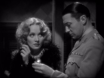 Movie still from “Shanghai Express” (1932), directed by Josef von Sternberg – A man and a woman are looking at each other; Close Up shot, Over the shoulder angle