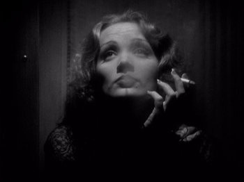 Movie still from “Shanghai Express” (1932), directed by Josef von Sternberg – A black and white photo of a woman in a black dress; Close Up shot, Low angle