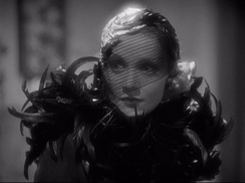 Movie still from “Shanghai Express” (1932), directed by Josef von Sternberg – A black and white photo of a woman wearing a veil; Close Up shot, Low angle