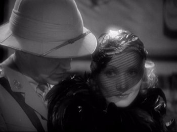 Movie still from “Shanghai Express” (1932), directed by Josef von Sternberg – A man and a woman are looking at each other through a veil; Close Up shot, Over the shoulder angle