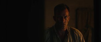 Movie still from “1922” (2017), directed by Zak Hilditch – A person in a dark room; Close Up shot, Over the shoulder angle