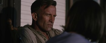 Movie still from “1922” (2017), directed by Zak Hilditch – A person sitting in front of a window; Close Up shot, Over the shoulder angle