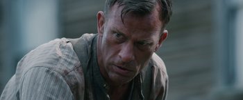 Movie still from “1922” (2017), directed by Zak Hilditch – A person wearing a shirt; Close Up shot, Over the shoulder angle