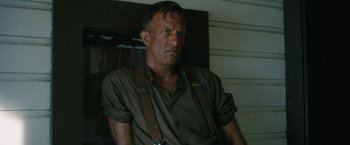 Movie still from “1922” (2017), directed by Zak Hilditch – A person wearing suspenders; Close Up shot, Low angle