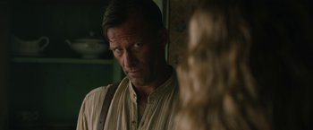 Movie still from “1922” (2017), directed by Zak Hilditch – A man standing next to a woman in front of a wall; Close Up shot, Over the shoulder angle