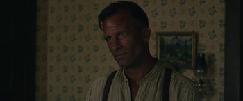 Movie still from “1922” (2017), directed by Zak Hilditch – A person wearing a shirt and suspenders; Close Up shot, Over the shoulder angle