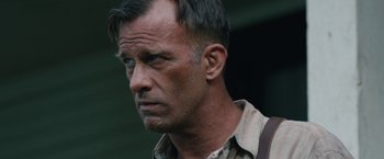 Movie still from “1922” (2017), directed by Zak Hilditch – A person wearing a shirt and tie; Close Up shot, Over the shoulder angle