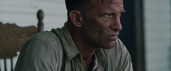 Movie still from “1922” (2017), directed by Zak Hilditch – A person wearing a shirt and tie; Close Up shot, Over the shoulder angle