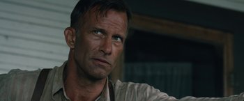 Movie still from “1922” (2017), directed by Zak Hilditch – A person looking at the camera; Close Up shot, Low angle