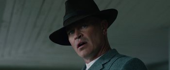 Movie still from “1922” (2017), directed by Zak Hilditch – A person wearing a suit and a hat; Close Up shot, Low angle