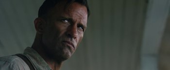Movie still from “1922” (2017), directed by Zak Hilditch – A man's face looking into the distance; Close Up shot, Low angle