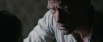 Movie still from “1922” (2017), directed by Zak Hilditch – A man's face in a white shirt; Extreme Close Up shot, Over the shoulder angle