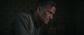 Movie still from “1922” (2017), directed by Zak Hilditch – A person wearing a shirt and tie; Close Up shot, Low angle