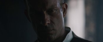 Movie still from “1922” (2017), directed by Zak Hilditch – A man's face in the dark; Close Up shot, Low angle