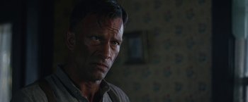Movie still from “1922” (2017), directed by Zak Hilditch – A person wearing a brown shirt; Close Up shot, Over the shoulder angle