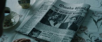 Movie still from “1922” (2017), directed by Zak Hilditch – An old newspaper with a picture of a man and a woman on it; Extreme Close Up shot, High angle