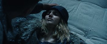 Movie still from “1922” (2017), directed by Zak Hilditch – A woman with wet hair wearing a hat; Close Up shot, Overhead angle