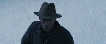 Movie still from “1922” (2017), directed by Zak Hilditch – A man wearing a hat and a jacket; Close Up shot, Over the shoulder angle