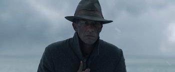 Movie still from “1922” (2017), directed by Zak Hilditch – A man in a hat and a coat; Close Up shot, Low angle