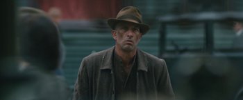 Movie still from “1922” (2017), directed by Zak Hilditch – A man wearing a hat and a coat; Close Up shot, Low angle