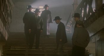 Movie still from “Shanghai Triad” (1995), directed by Yimou Zhang – A group of men standing next to each other in suits; Wide shot, Low angle