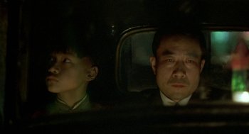 Movie still from “Shanghai Triad” (1995), directed by Yimou Zhang – A man and a boy sitting in the back of a car; Close Up shot, Over the shoulder angle