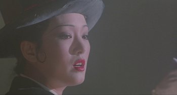 Movie still from “Shanghai Triad” (1995), directed by Yimou Zhang – A person wearing a hat; Close Up shot, Low angle