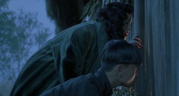 Movie still from “Shanghai Triad” (1995), directed by Yimou Zhang – A woman leaning against a pole next to another woman; Close Up shot, Over the shoulder angle
