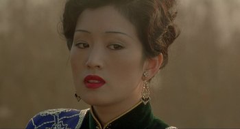 Movie still from “Shanghai Triad” (1995), directed by Yimou Zhang – A person wearing a dress; Close Up shot, High angle