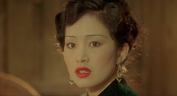 Movie still from “Shanghai Triad” (1995), directed by Yimou Zhang – A person wearing a green shirt; Close Up shot, Over the shoulder angle