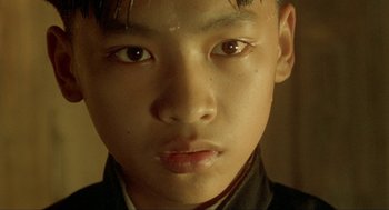 Movie still from “Shanghai Triad” (1995), directed by Yimou Zhang – A young asian boy's face; Close Up shot, High angle