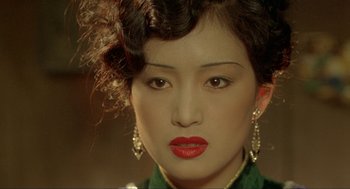 Movie still from “Shanghai Triad” (1995), directed by Yimou Zhang – A person wearing a green shirt; Close Up shot, High angle
