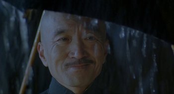 Movie still from “Shanghai Triad” (1995), directed by Yimou Zhang – A person looking through a window; Close Up shot, Over the shoulder angle